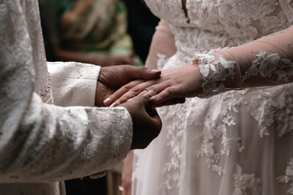 A second wedding photographer capturing the bride and groom during their wedding ceremony