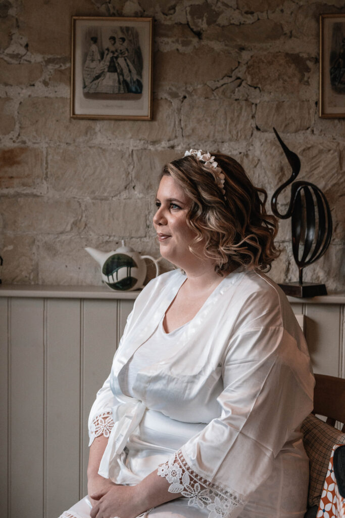 A second wedding photographer capturing the bride getting ready for her wedding day