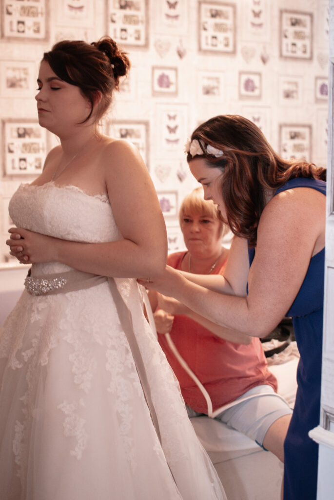 The bride getting ready into her wedding dress which was scheduled into their wedding day timeline