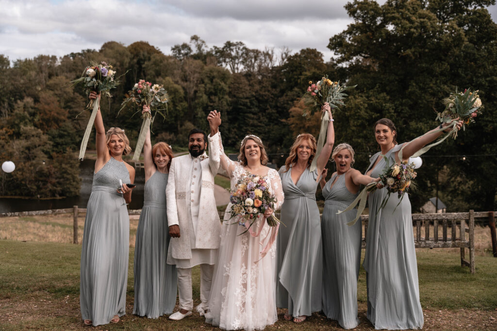 The bride and bridal party having group shots together which was scheduled into their wedding day timeline