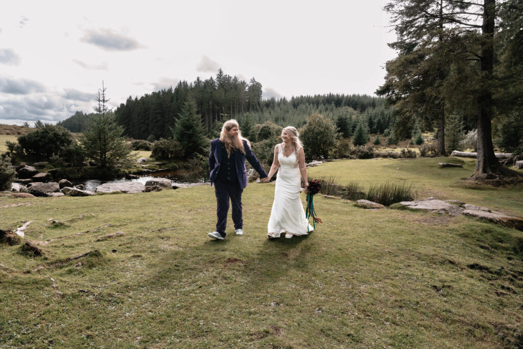 Documentary-style wedding photography of the bride and groom walking hand in hand
