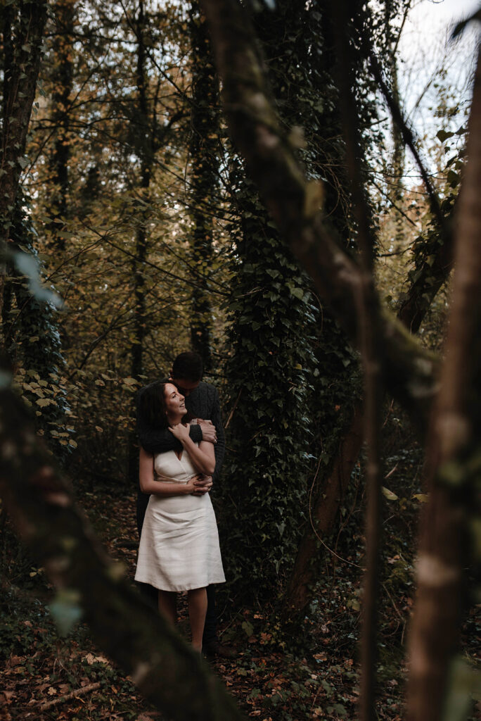 A couple during their intimate engagement photoshoot int he woodlands
