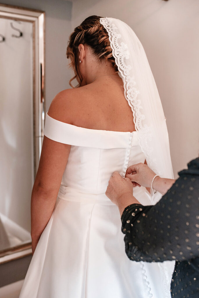 The bride getting ready into her wedding dress which was scheduled into their wedding day timeline